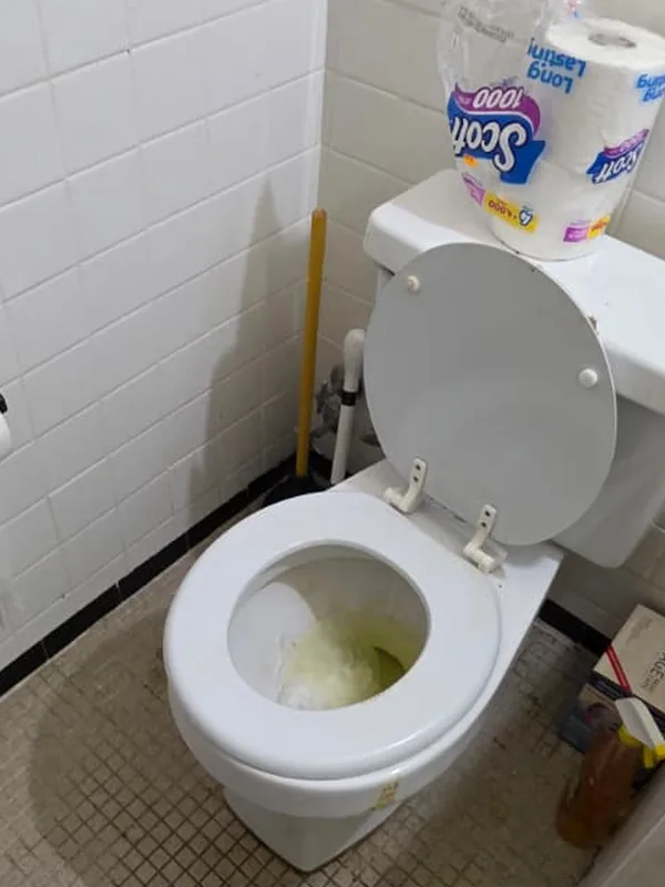 Bathroom toilet with a stained bowl before cleaning